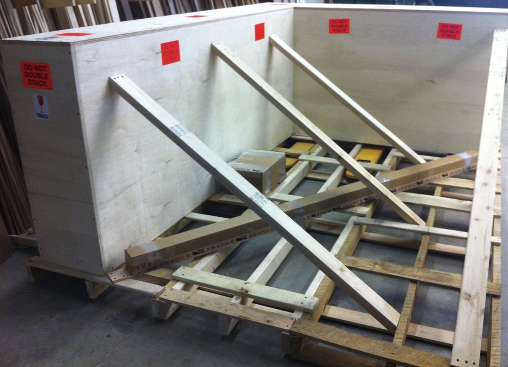 custom crate for 2 - 90 degree corner frames Custom made wooden crate and pallet.