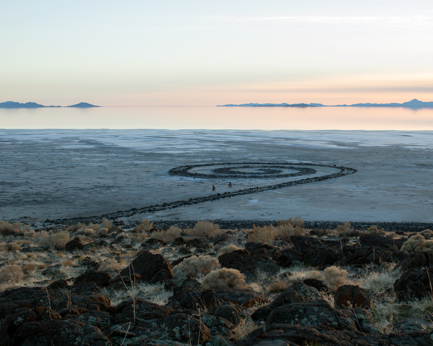 Todd Stewart, Bicyclists, at Smithson's Spiral Jetty, Utah, 2014, archival inkjet print, 16x20 inches, Courtesy of the artist