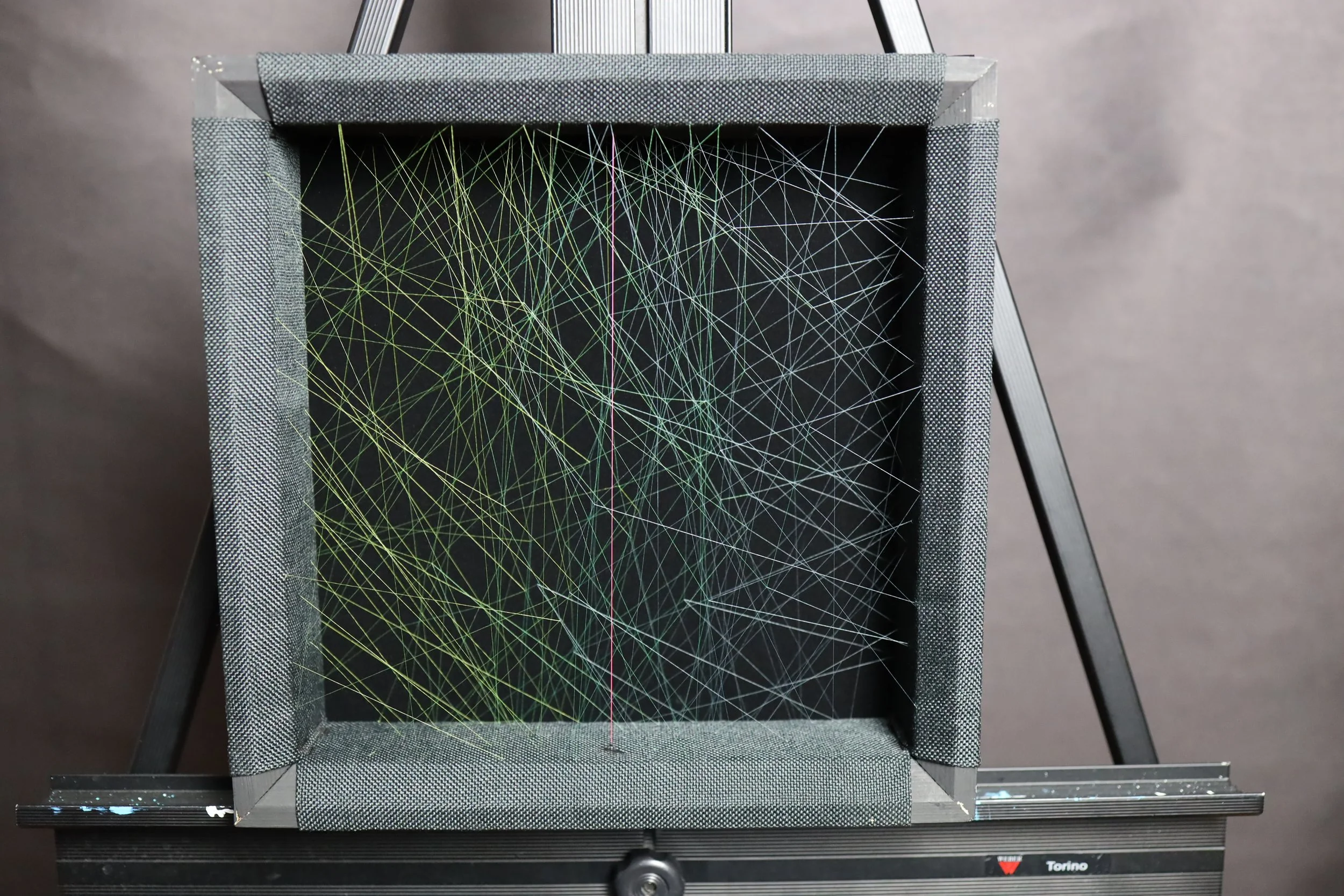 fabric covered strainer I'll then build a frame that is 2.5 inches deep, I upholster a burlap-like fabric to the frame which I use as a grid to sew the silk in. From there, each piece of silk is individually tied into the frame, working from the back to front, until a piece is completed.