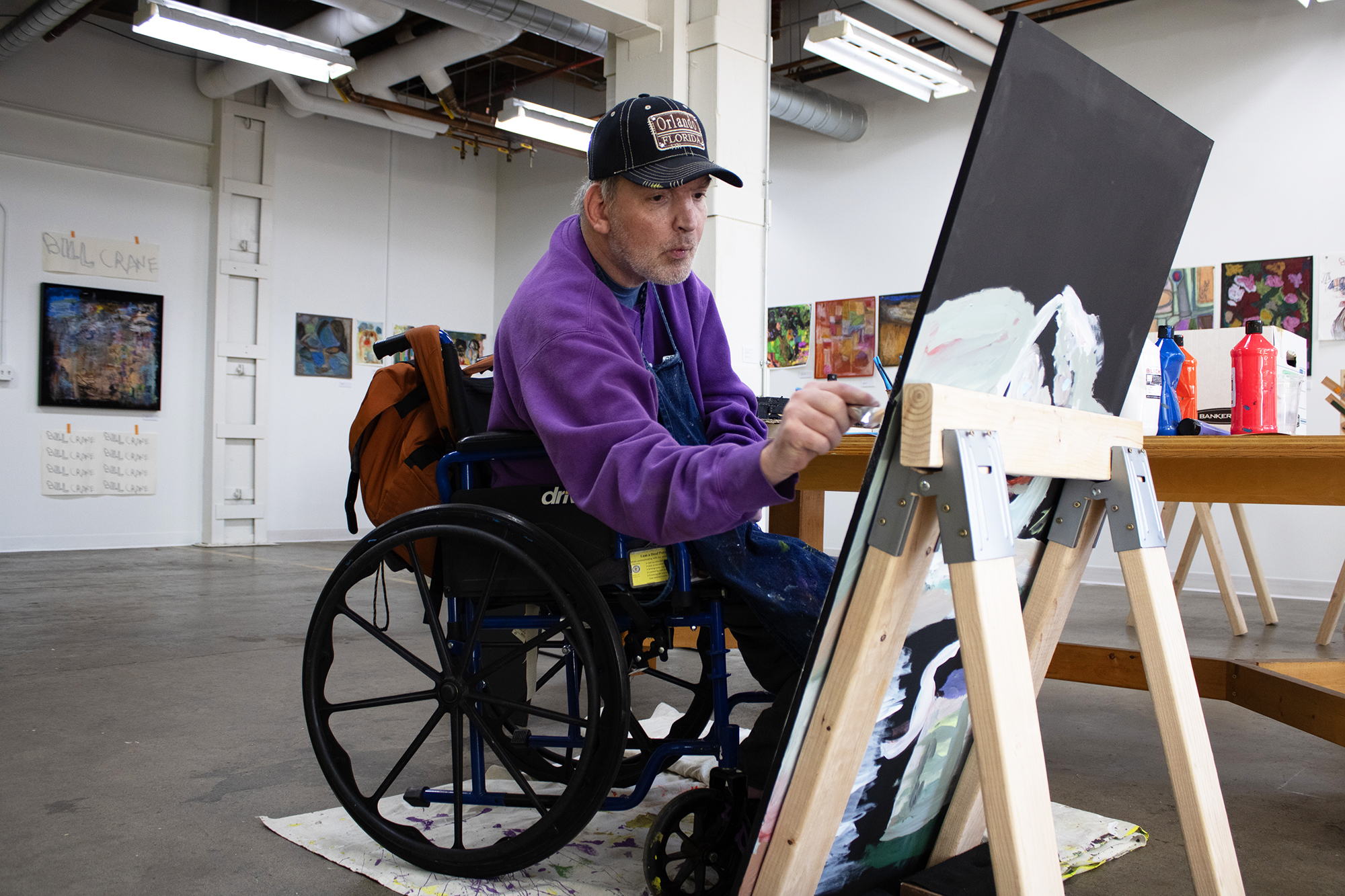 Artist Bill Crane, who has practiced at Interact since 2002,
works on a painting during his residency at Interact Gallery in 2024.
